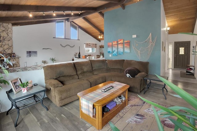 living room with wood ceiling, light hardwood / wood-style floors, rail lighting, ceiling fan, and beam ceiling