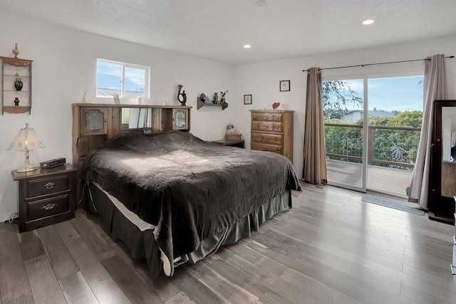 bedroom with access to exterior, multiple windows, and light wood-type flooring