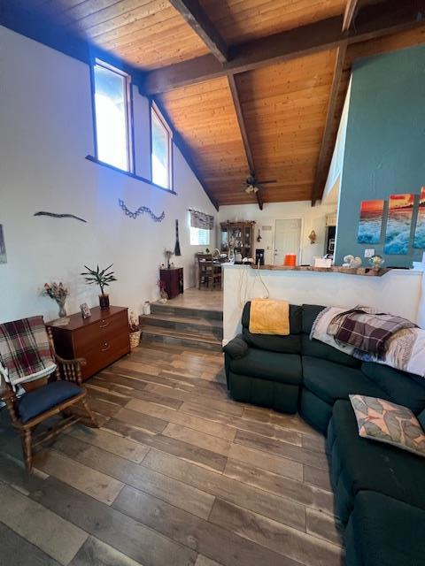 living room featuring wood ceiling, beamed ceiling, ceiling fan, high vaulted ceiling, and hardwood / wood-style flooring