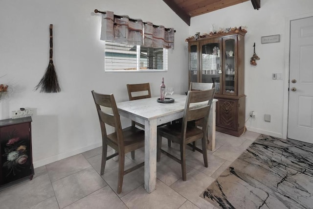 dining space featuring wooden ceiling and vaulted ceiling with beams