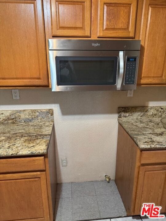 kitchen featuring light stone counters