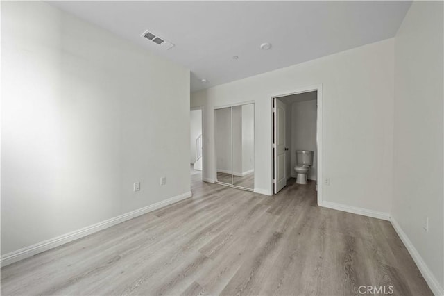 spare room featuring light hardwood / wood-style floors