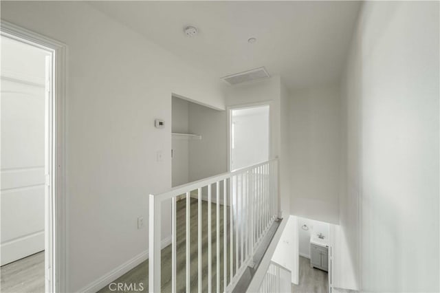 hallway featuring baseboards and wood finished floors