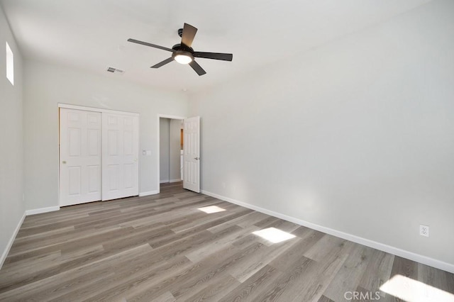 unfurnished bedroom featuring a closet, ceiling fan, and hardwood / wood-style floors