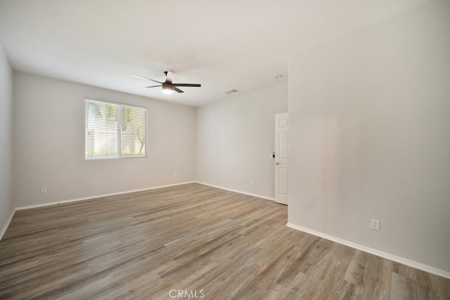 empty room featuring ceiling fan and wood-type flooring