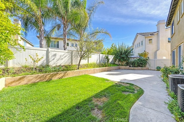 view of yard featuring a patio and central AC