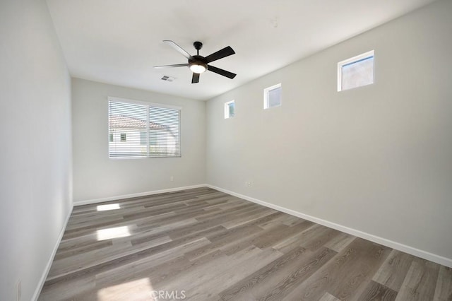 spare room featuring wood-type flooring and ceiling fan