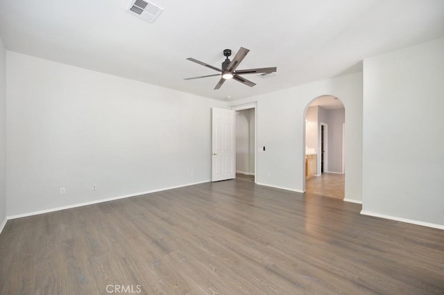 spare room featuring ceiling fan and dark hardwood / wood-style flooring