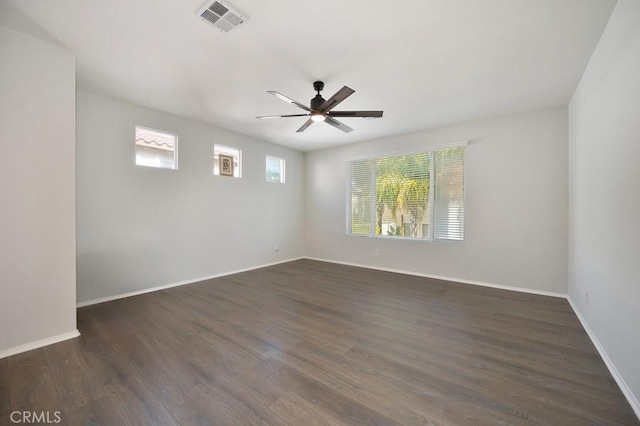 unfurnished room with dark hardwood / wood-style floors, ceiling fan, and a wealth of natural light