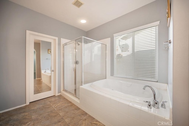 bathroom with tile patterned floors and separate shower and tub