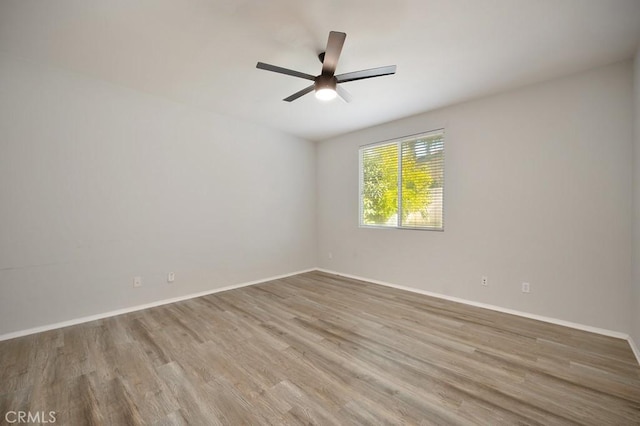 spare room with hardwood / wood-style floors and ceiling fan