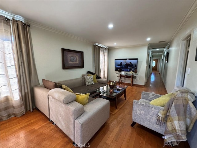 living room featuring hardwood / wood-style floors and crown molding