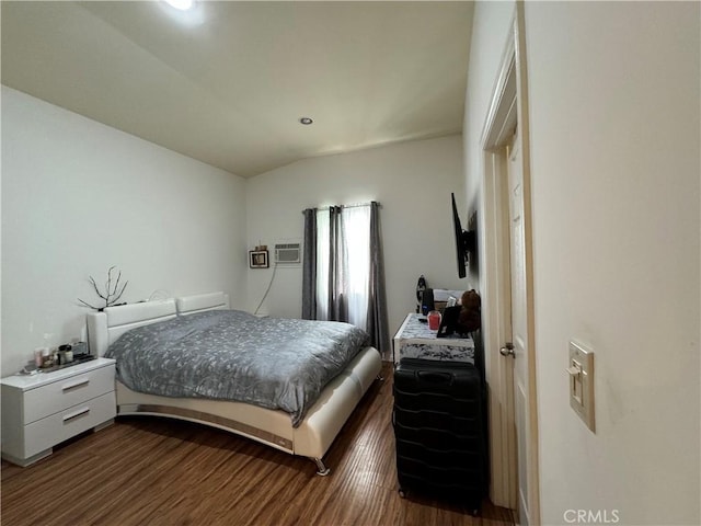 bedroom with dark hardwood / wood-style flooring and vaulted ceiling