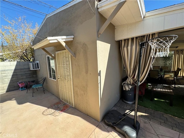 view of exterior entry featuring a patio