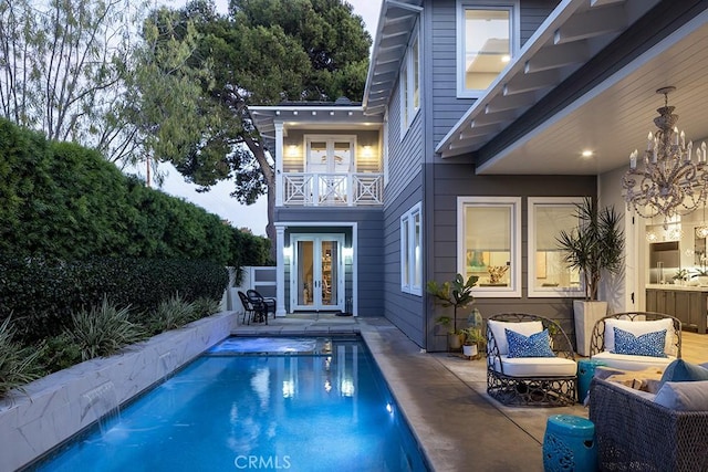 view of pool with french doors