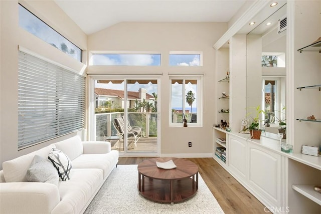 living room with lofted ceiling and light hardwood / wood-style flooring