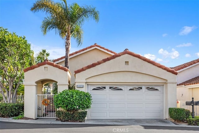 mediterranean / spanish-style home with a garage