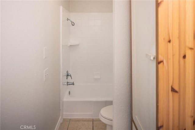 bathroom featuring tile patterned flooring, shower / bath combination, and toilet