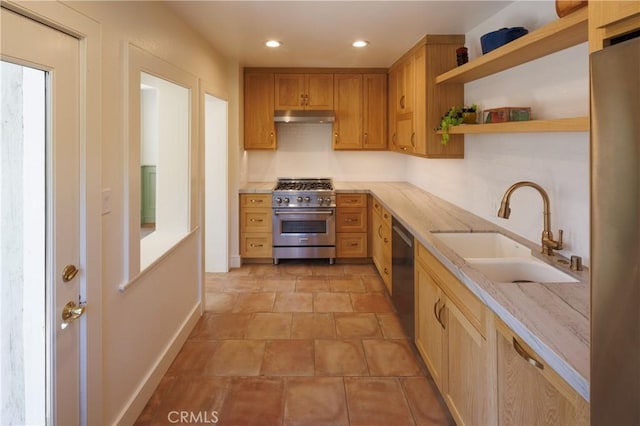 kitchen with black dishwasher, high end stainless steel range, and sink