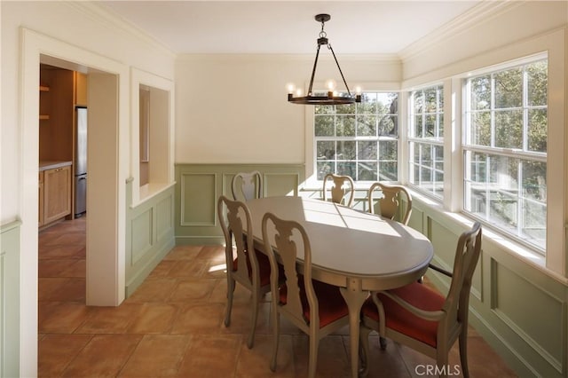 dining area with a chandelier and crown molding