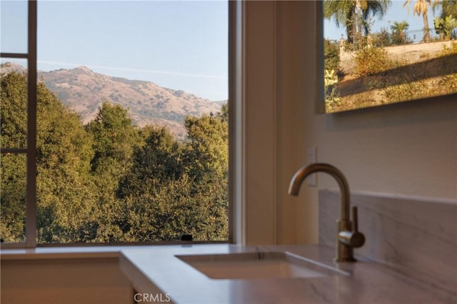 interior details featuring a mountain view and sink