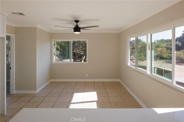 spare room with light tile patterned floors, ceiling fan, and ornamental molding