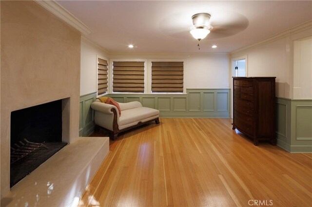 unfurnished room with built in shelves, light hardwood / wood-style floors, and ornamental molding