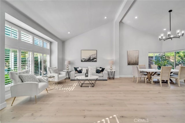 living room with a notable chandelier, light hardwood / wood-style floors, beam ceiling, and high vaulted ceiling