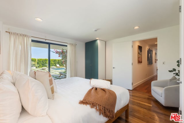 bedroom featuring access to exterior and dark wood-type flooring