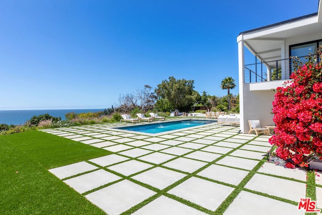 view of pool featuring a patio, a water view, and pool water feature