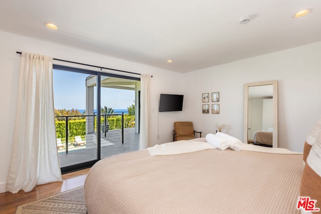 bedroom featuring access to exterior and light hardwood / wood-style flooring