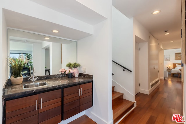 bathroom with hardwood / wood-style floors and vanity