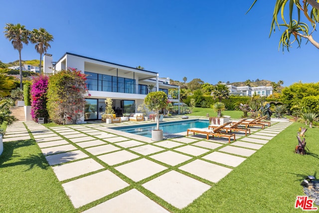 view of swimming pool featuring a yard and a patio