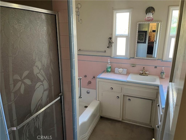 bathroom featuring vanity, tile walls, and plus walk in shower