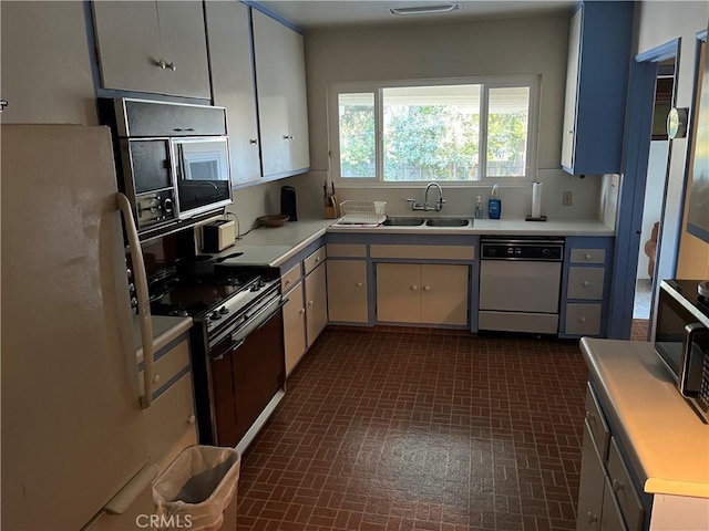 kitchen with black range, white refrigerator, sink, dishwashing machine, and white cabinetry