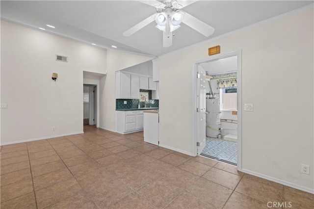 kitchen featuring light tile patterned floors, ceiling fan, white cabinets, decorative backsplash, and vaulted ceiling