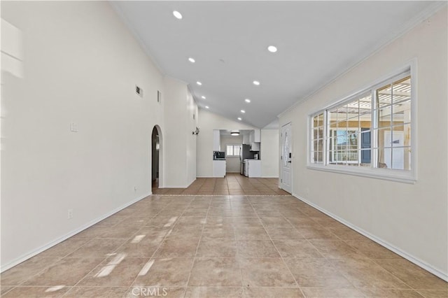 interior space with ornamental molding and vaulted ceiling