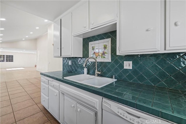 kitchen with white cabinetry, sink, and tile counters