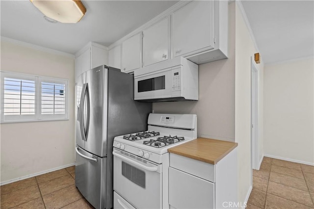 kitchen featuring white cabinetry, crown molding, light tile patterned flooring, and white appliances