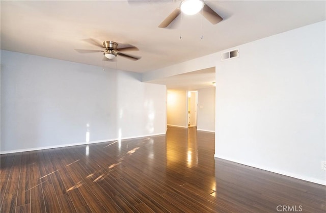 spare room featuring dark hardwood / wood-style flooring and ceiling fan