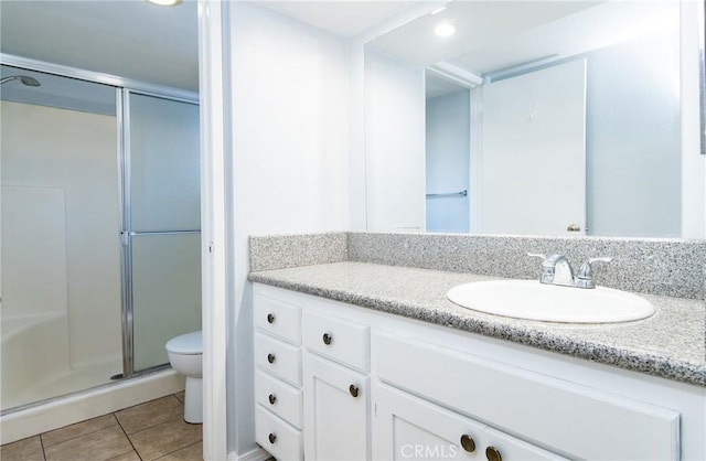 bathroom featuring walk in shower, tile patterned flooring, vanity, and toilet