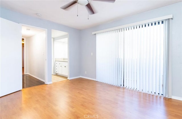 unfurnished room with ceiling fan and light hardwood / wood-style flooring