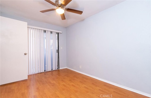 empty room with wood-type flooring and ceiling fan