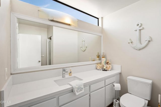 bathroom featuring vanity, an enclosed shower, and toilet