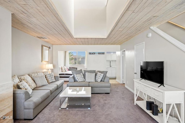 living room featuring carpet floors and wood ceiling