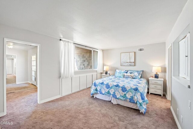 carpeted bedroom with multiple windows