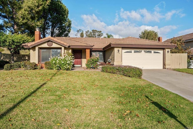 ranch-style home featuring a garage and a front lawn