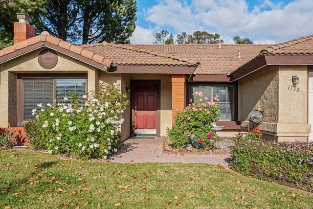 property entrance with a yard