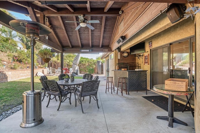 view of patio featuring ceiling fan and an outdoor bar