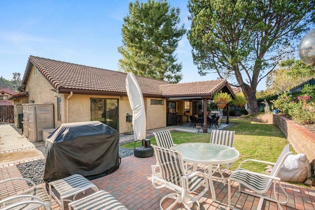 rear view of property featuring a patio area and a yard